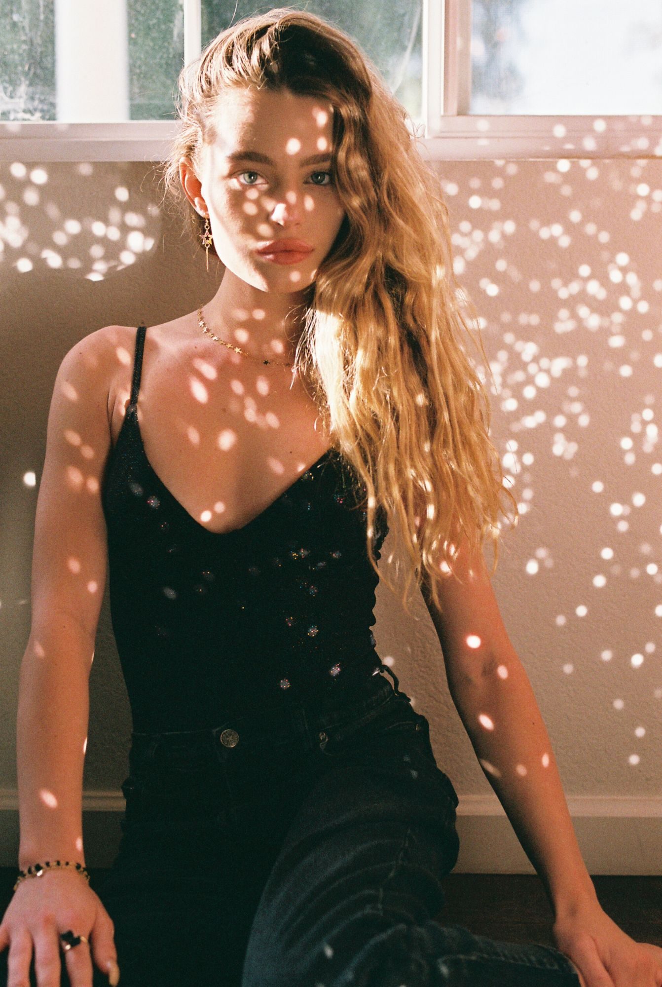 35mm film portrait in dappled window light with a star necklace and star drop earrings